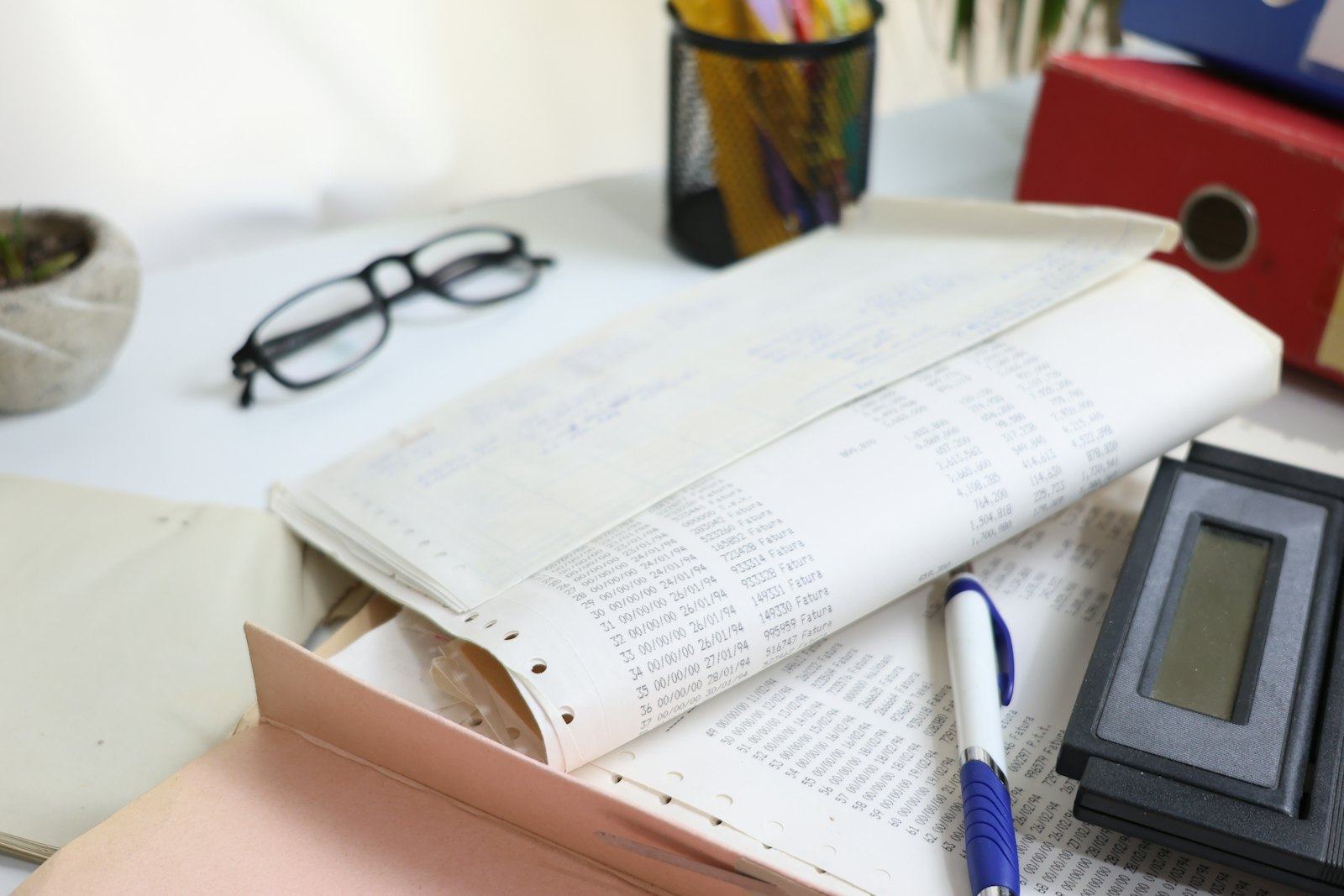 Paper forms and spreadsheets on a desk